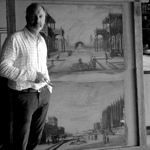 Tim Everett standing beside a large painting in the studio in Somerset