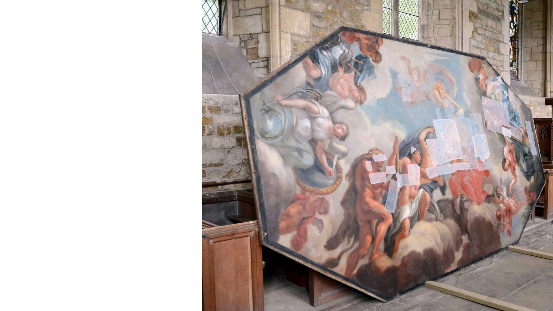 Close-up of a conservator's hand retouching a historic painted panel with a fine brush